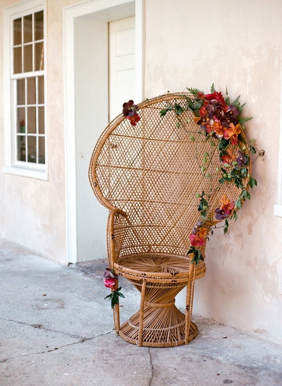 Peacock chair with burgundy flowers for bohemian wedding | E.M. Anderson via 100 Layer Cake