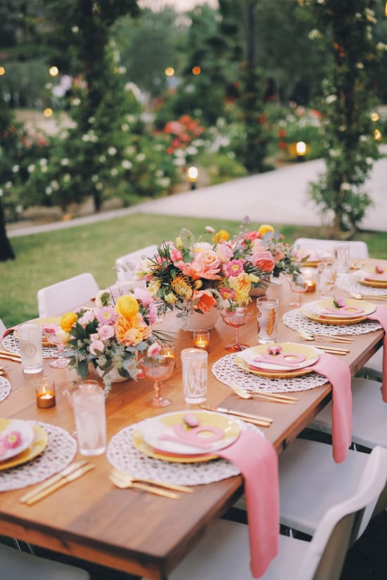Bright tropical wedding reception table with pink and orange flowers | Gideon Photography