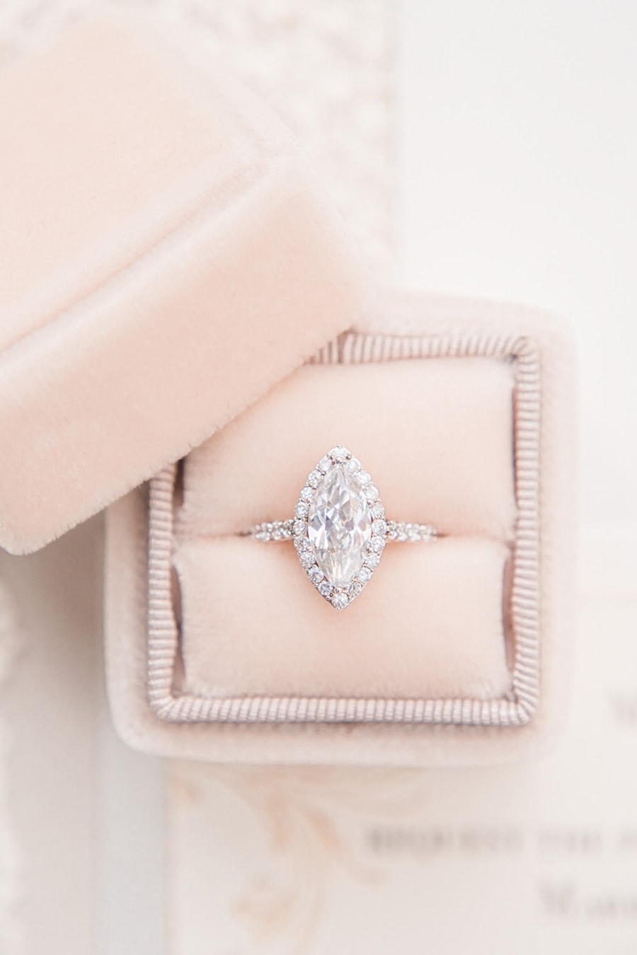 Rose gold marquise halo diamond engagement ring with pave band displayed in blush velvet ring box | Photography: Joanna Briggs Photography via Whimsical Wonderland Weddings