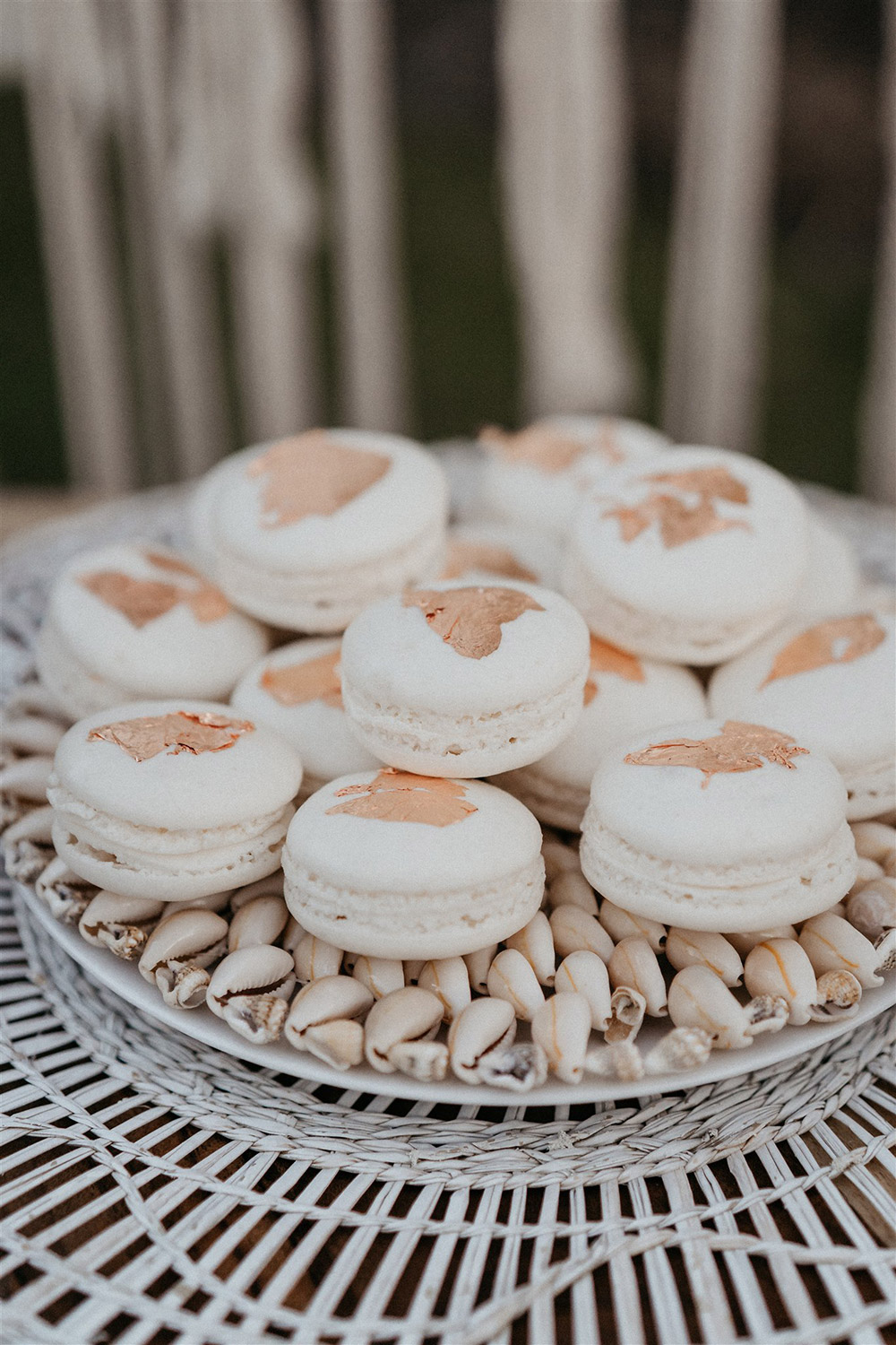 Outdoor Festival Bohemian Wedding Inspiration | A stack of white macarons topped with gold leaf for a bohemian wedding dessert table. | Photography: Shae Estella Photo