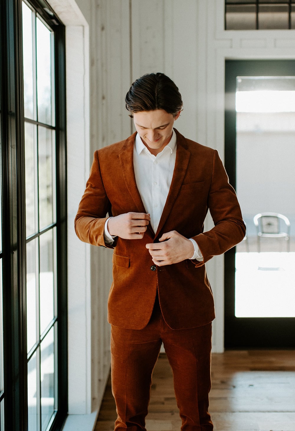 Boho Rust & White Wedding Ideas | Groom wearing a rust coloured wedding suit with a white shirt and no tie. | Photography: Peyton Rainey Photography