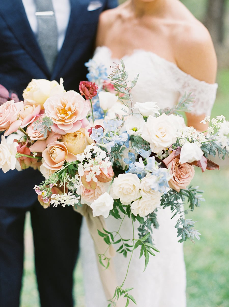 Spring Pastel Wedding Ideas | Romantic pastel wedding bouquet in pale blue, blush pink, butter yellow and white featuring roses, delphinium, and greenery. | Photography: Brittany Jean Photography